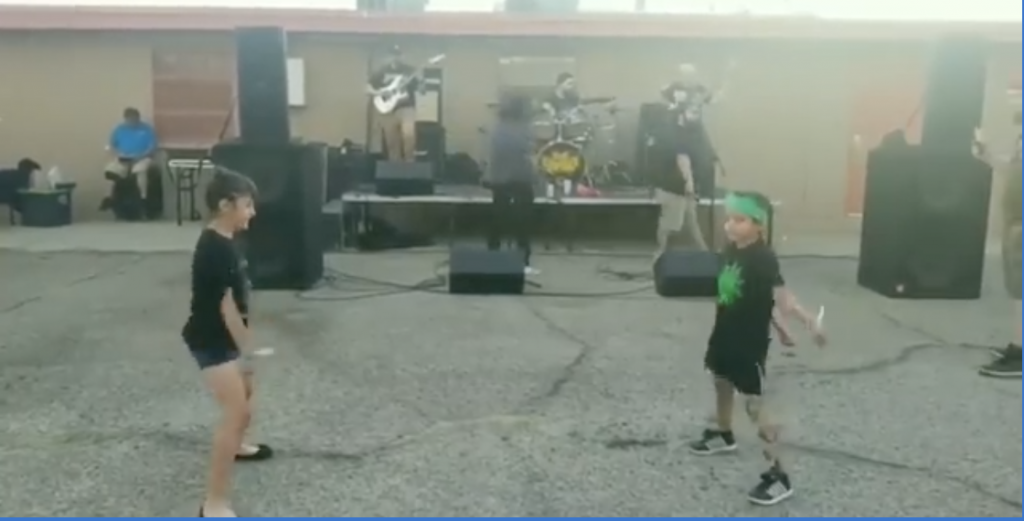 Kids participate in “the floss” dance at metal show