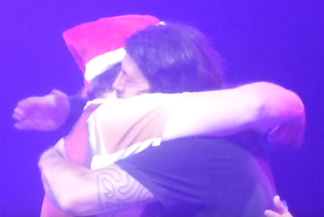 Dave Grohl shotguns beer with Santa Claus